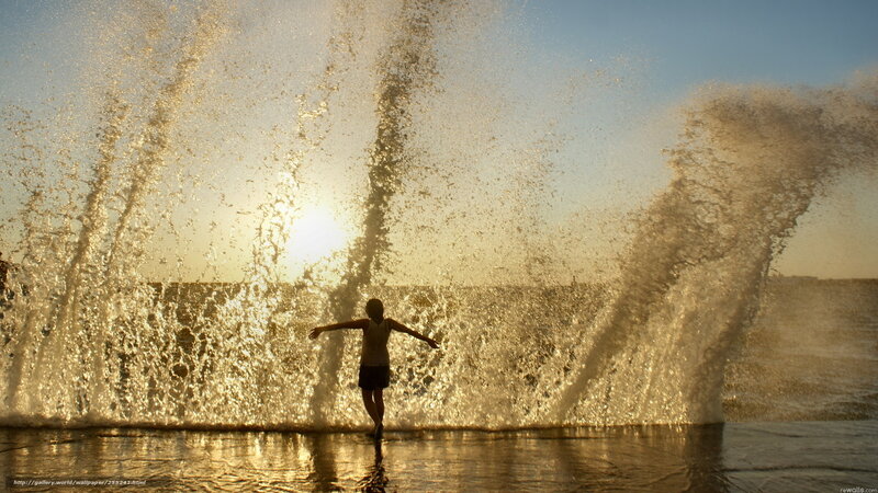 Child playing in ocean waves