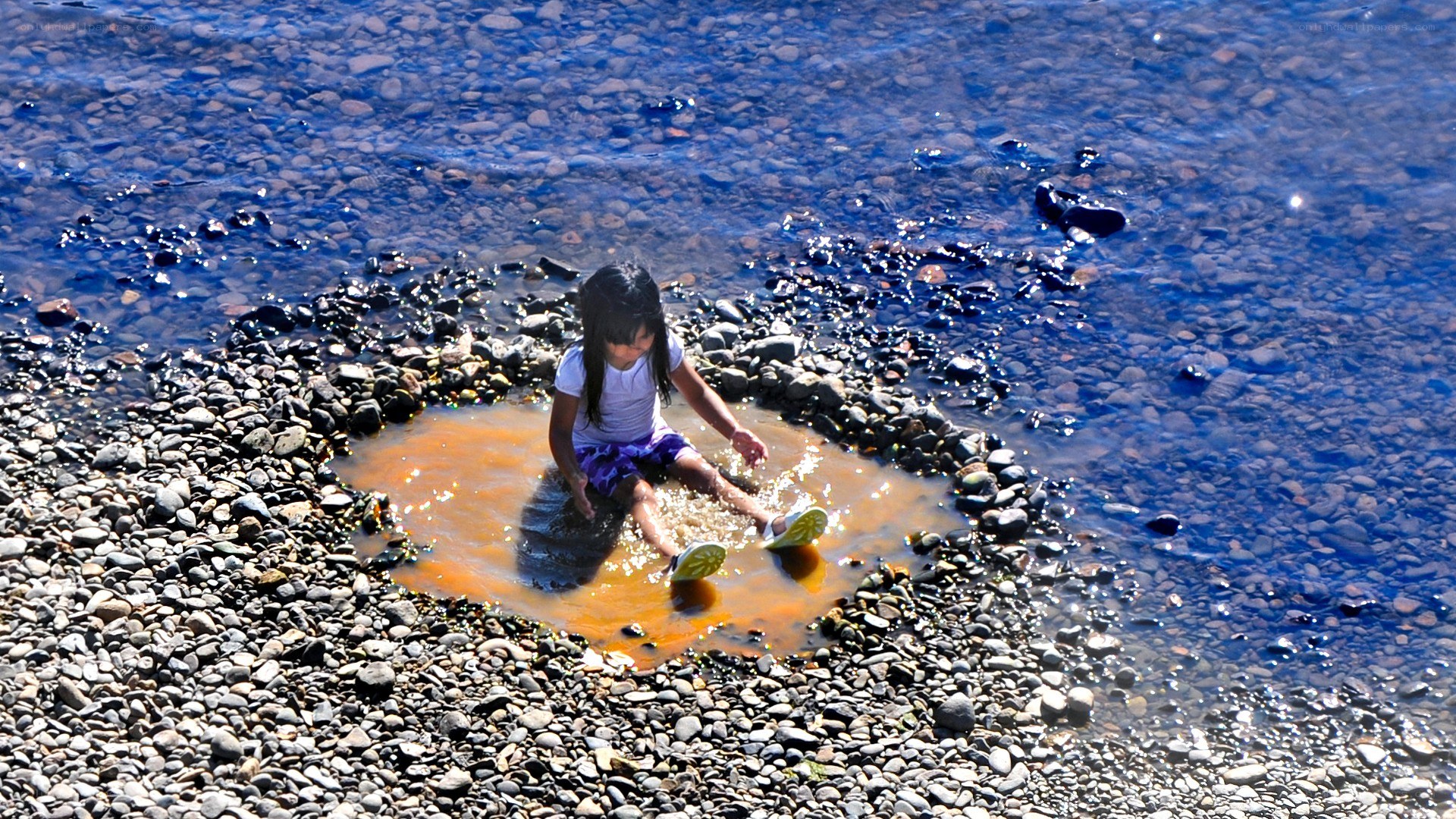 child playing in river water