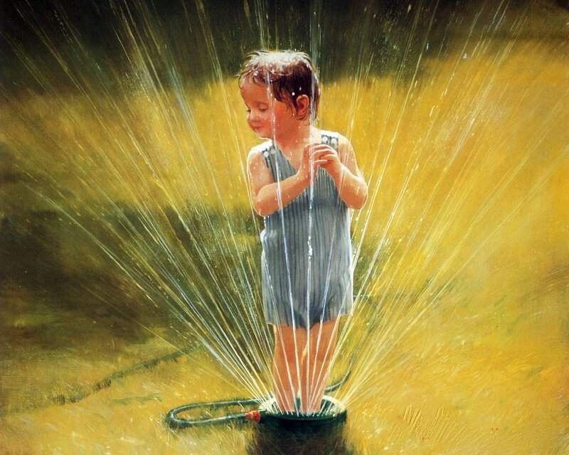 child playing in sprinkler