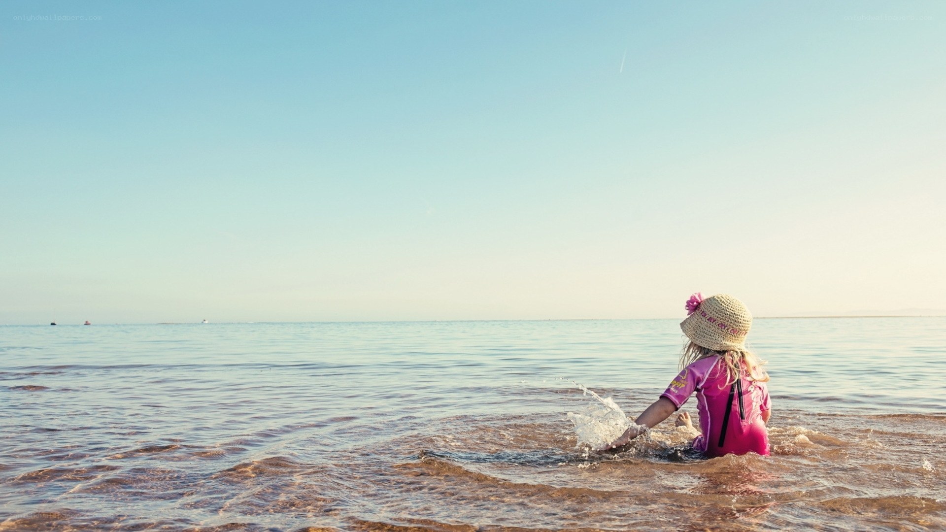 child playing in the ocean