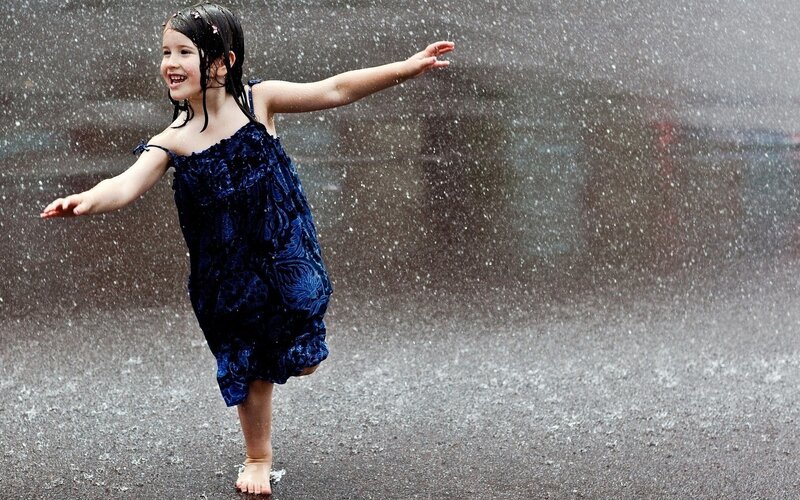 child playing in the rain
