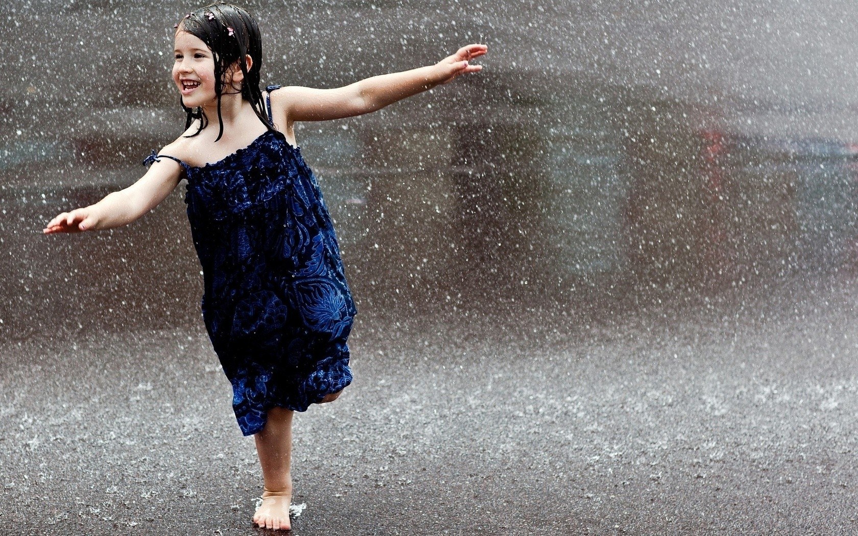 child playing in the rain