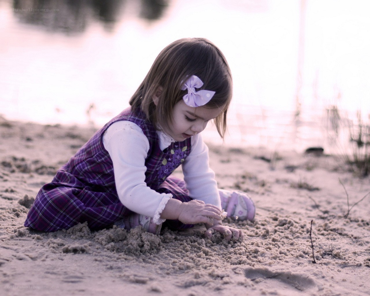 child playing in the sand