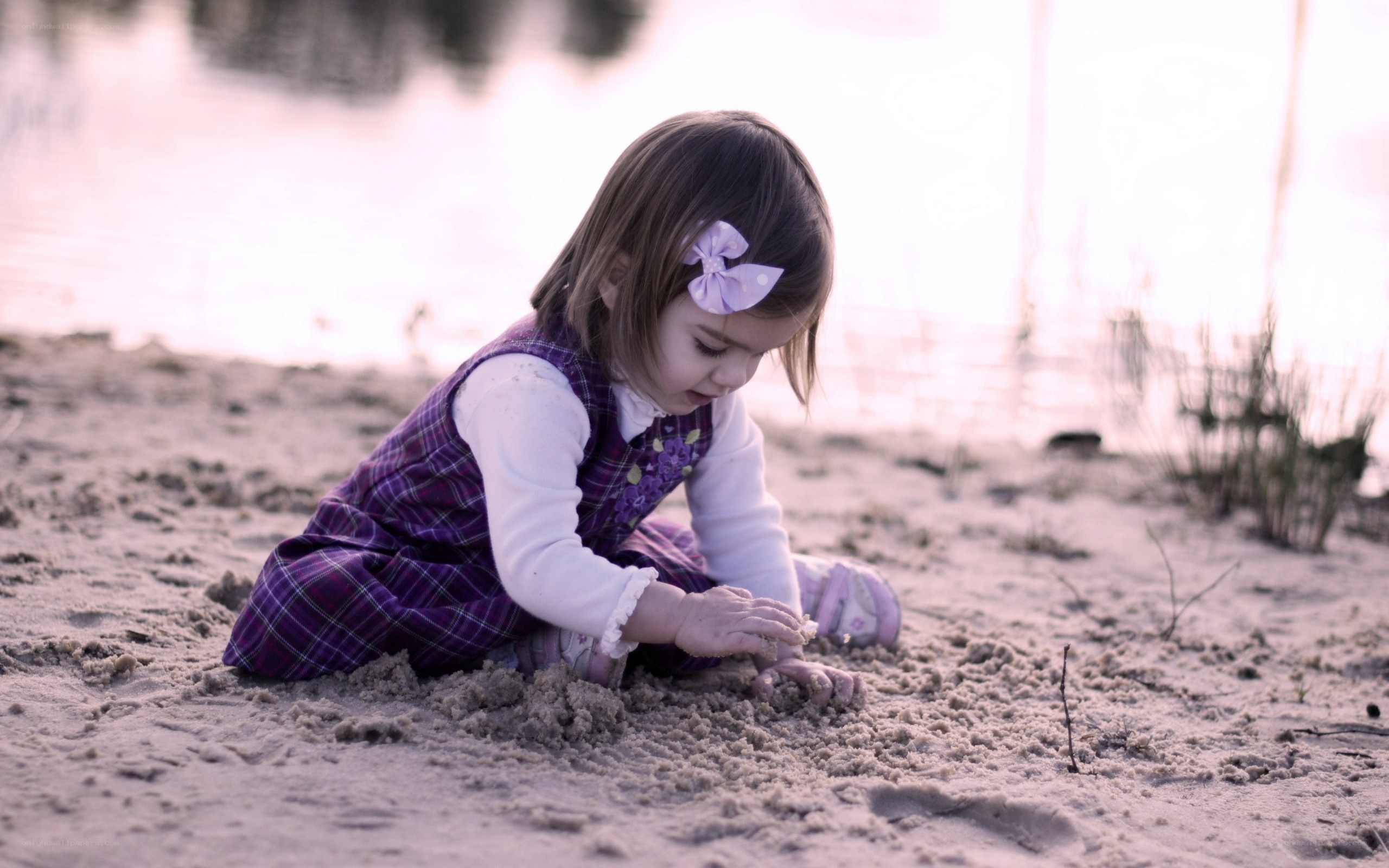 child playing in the sand