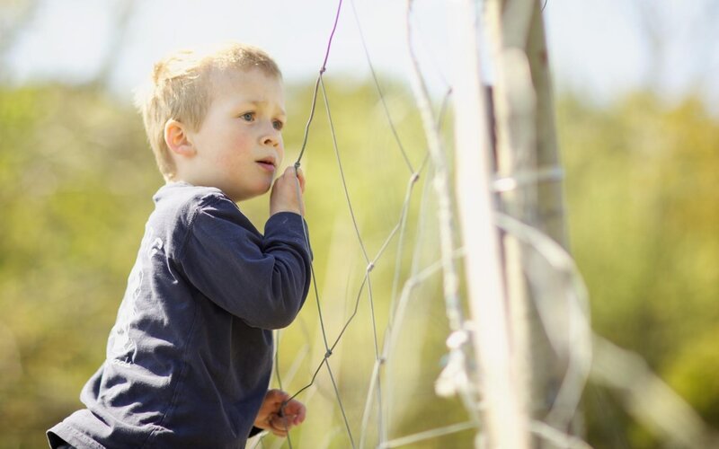 child playing near fence