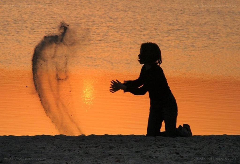 child playing on beach at sunset