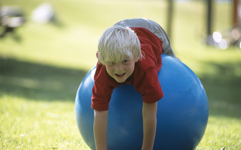 child playing on exercise ball