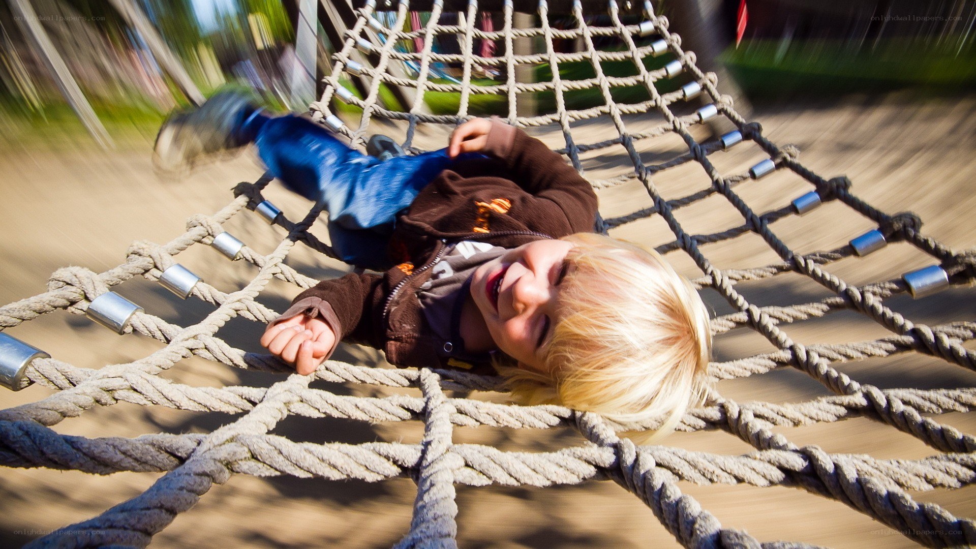 child playing on rope bridge