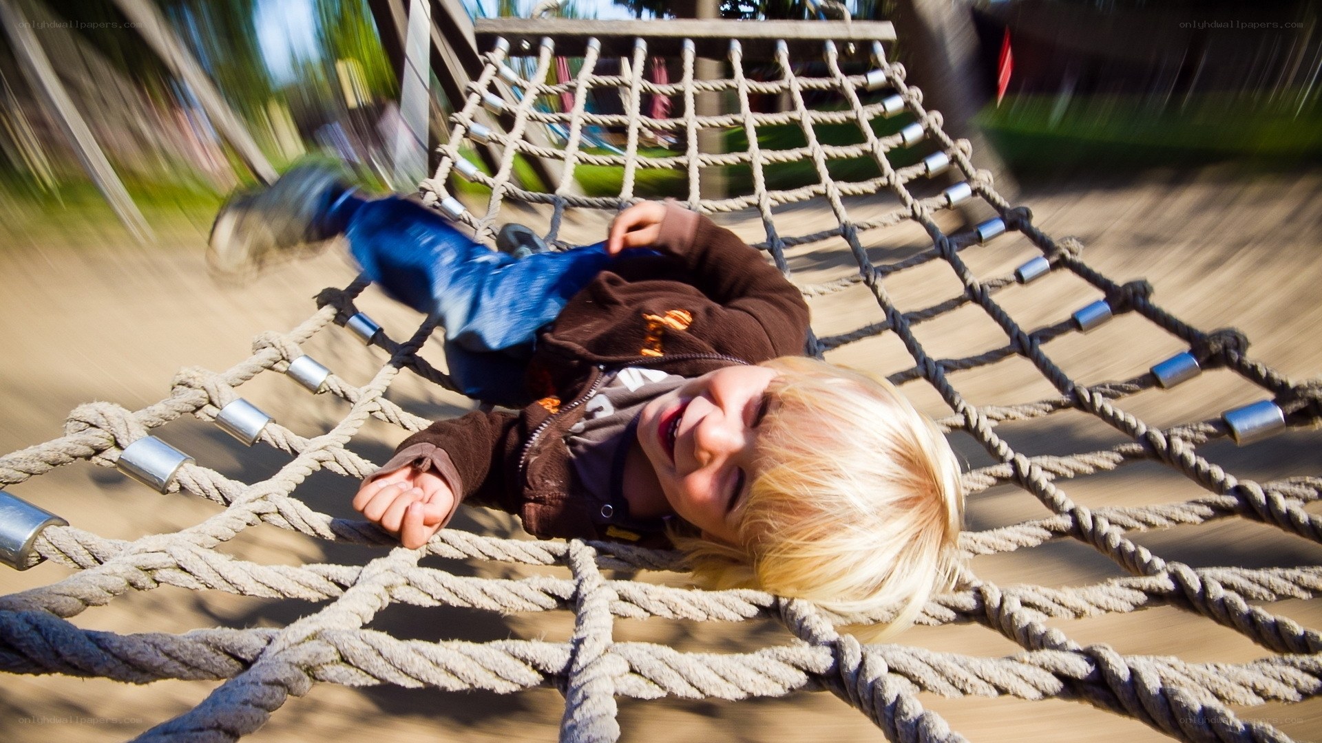 child playing on rope bridge