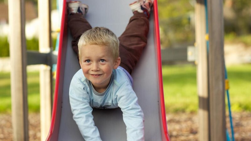 child playing on slide