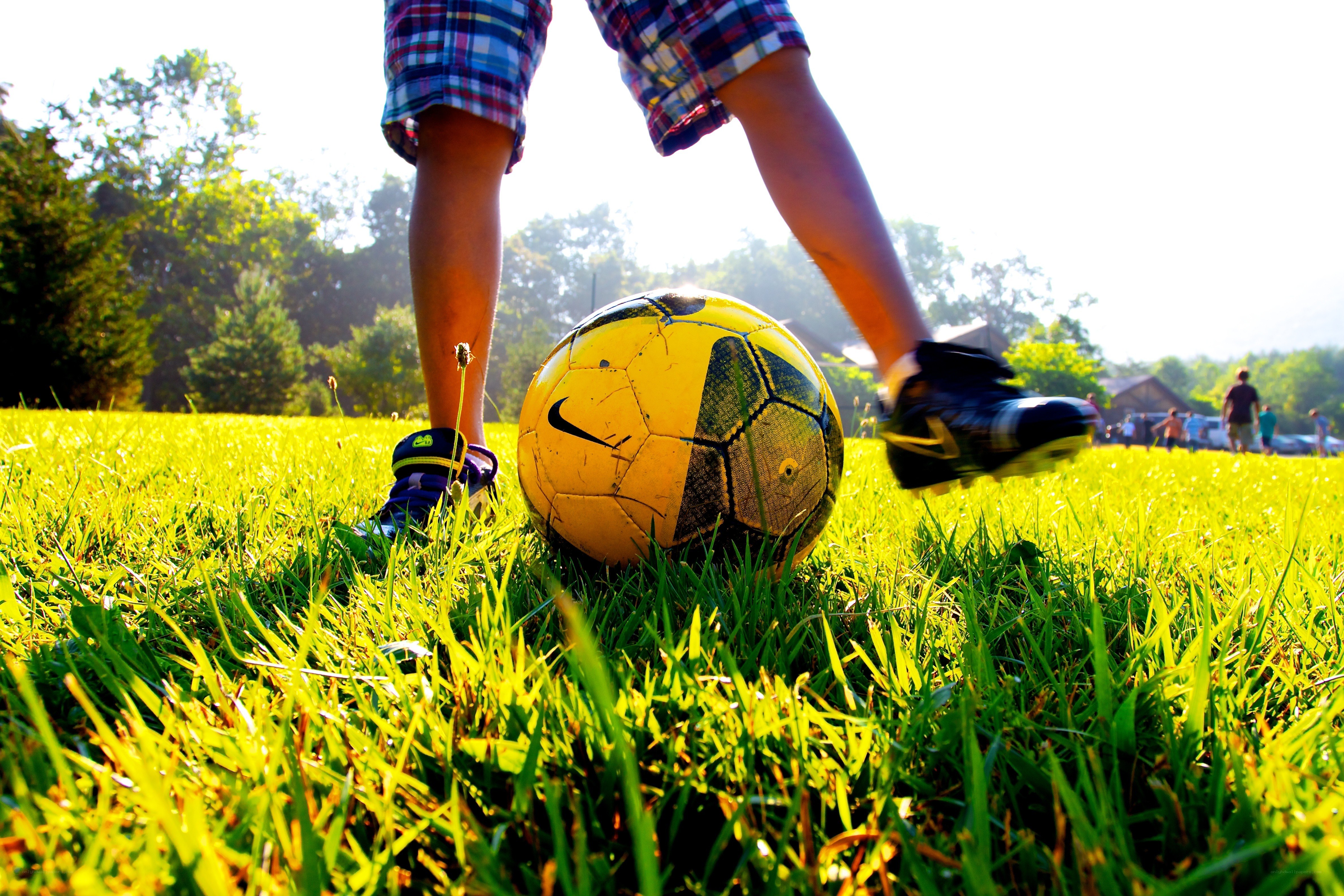child playing soccer on grass