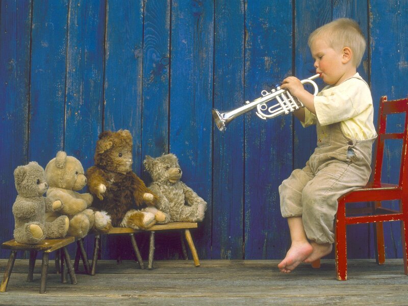 child playing trumpet for teddy bears