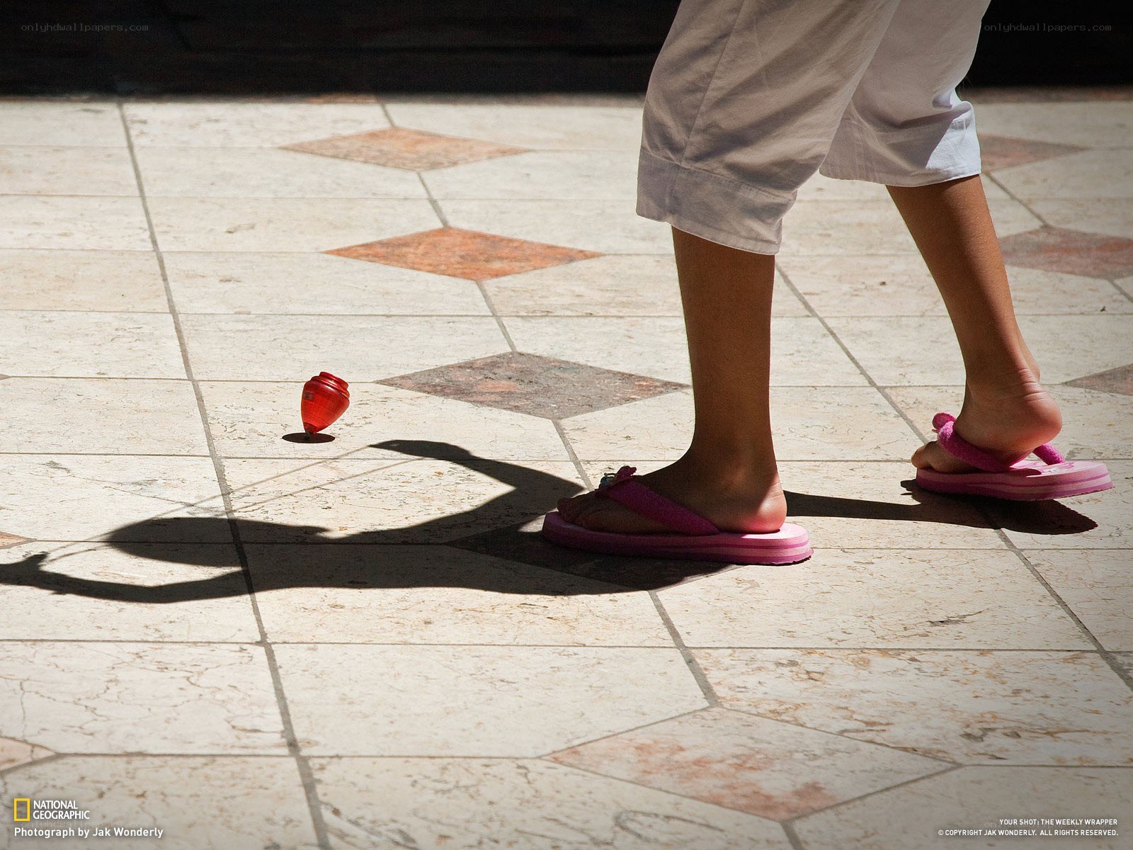 Child playing with a spinning top