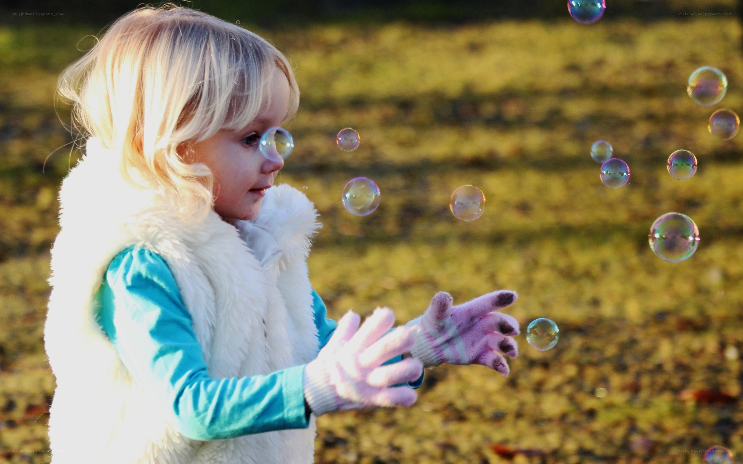 child playing with bubbles