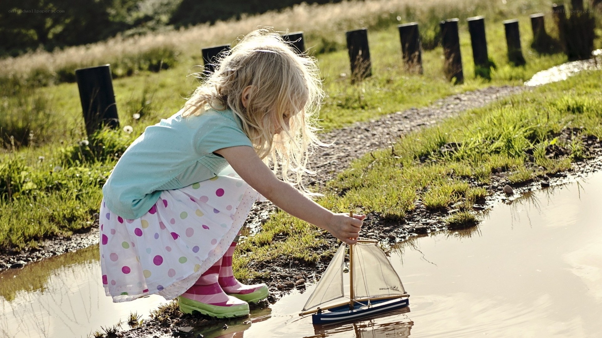 child playing with toy boat