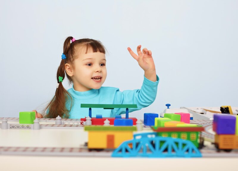 child playing with toy train