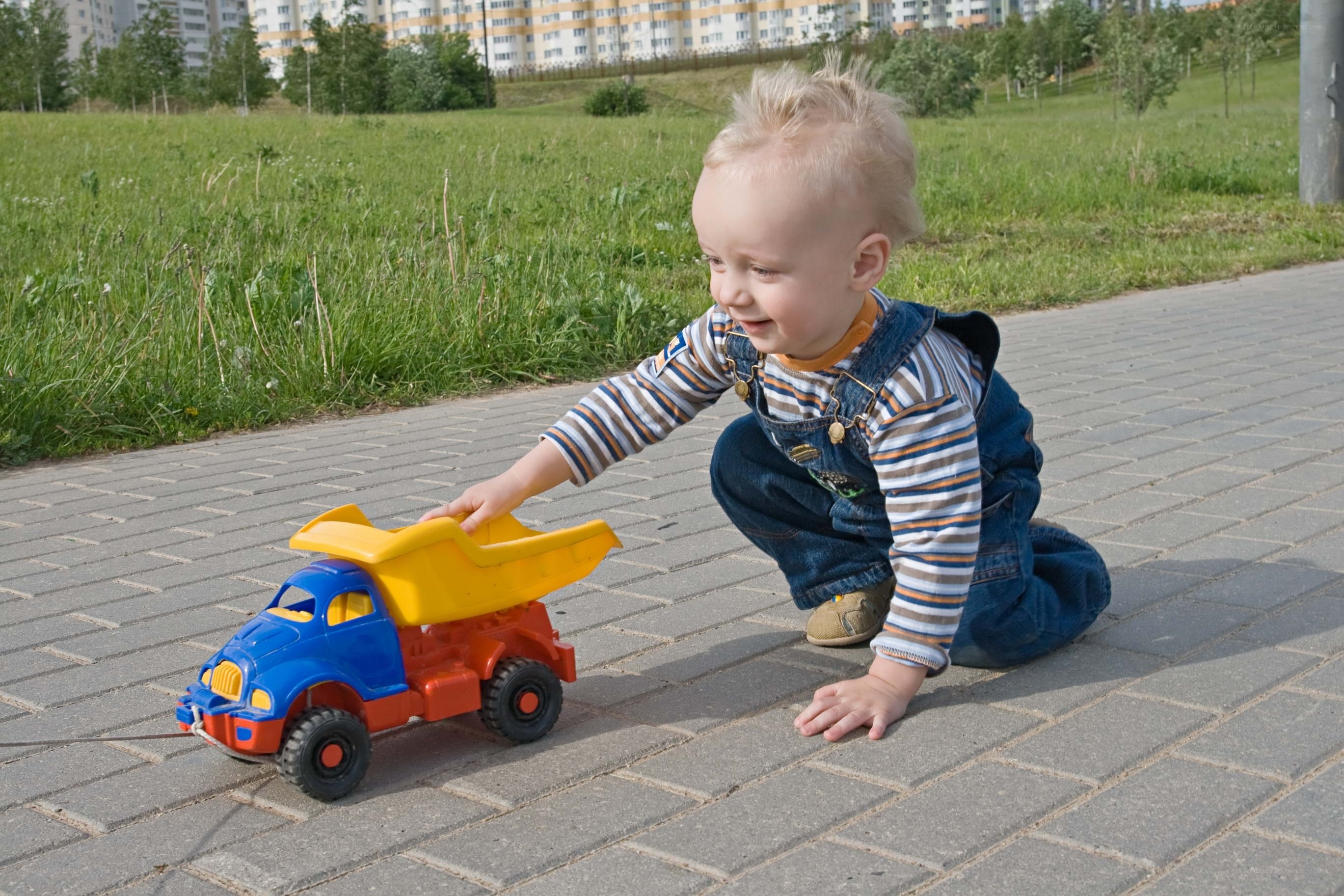 child playing with toy truck