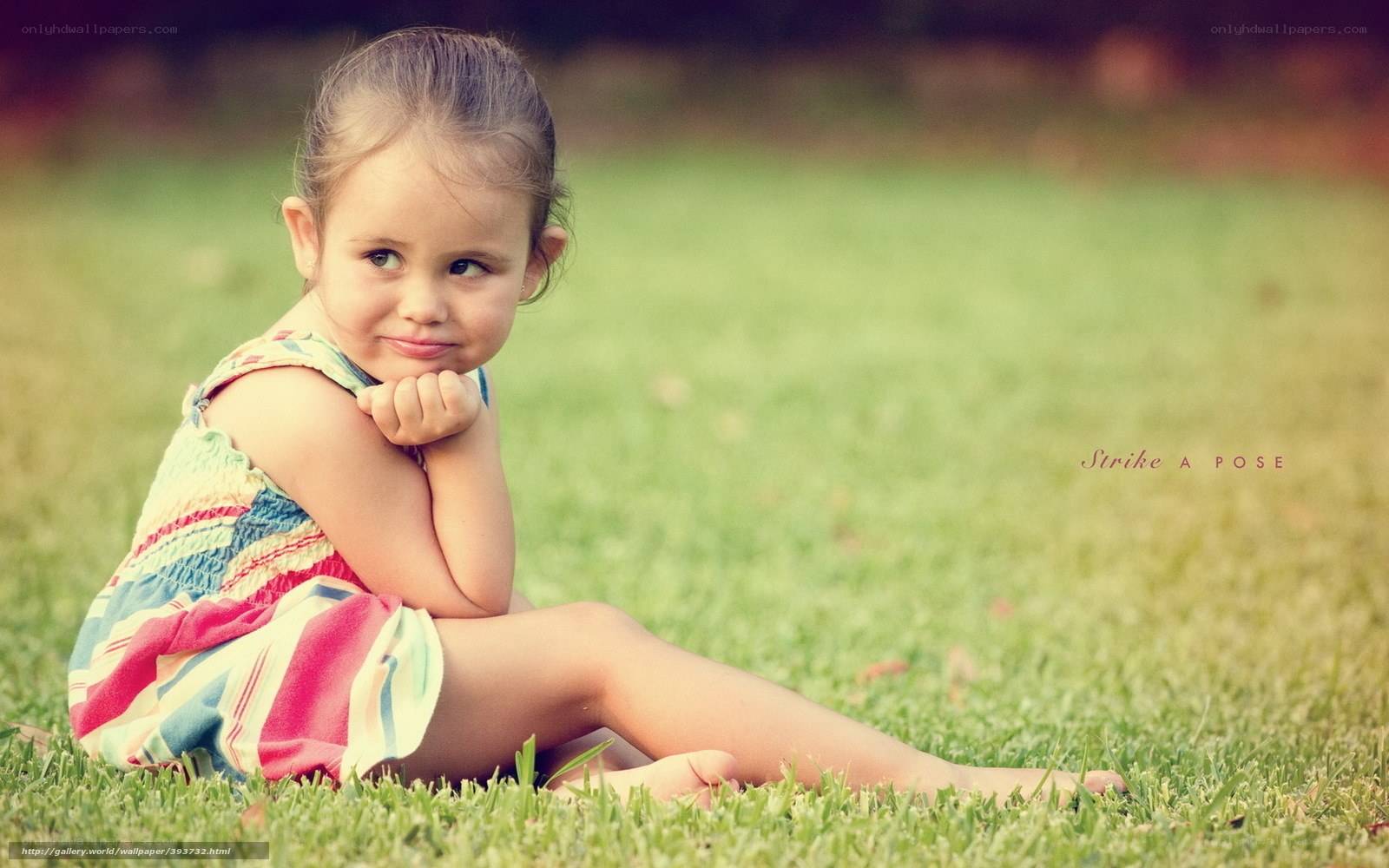 child posing on grass