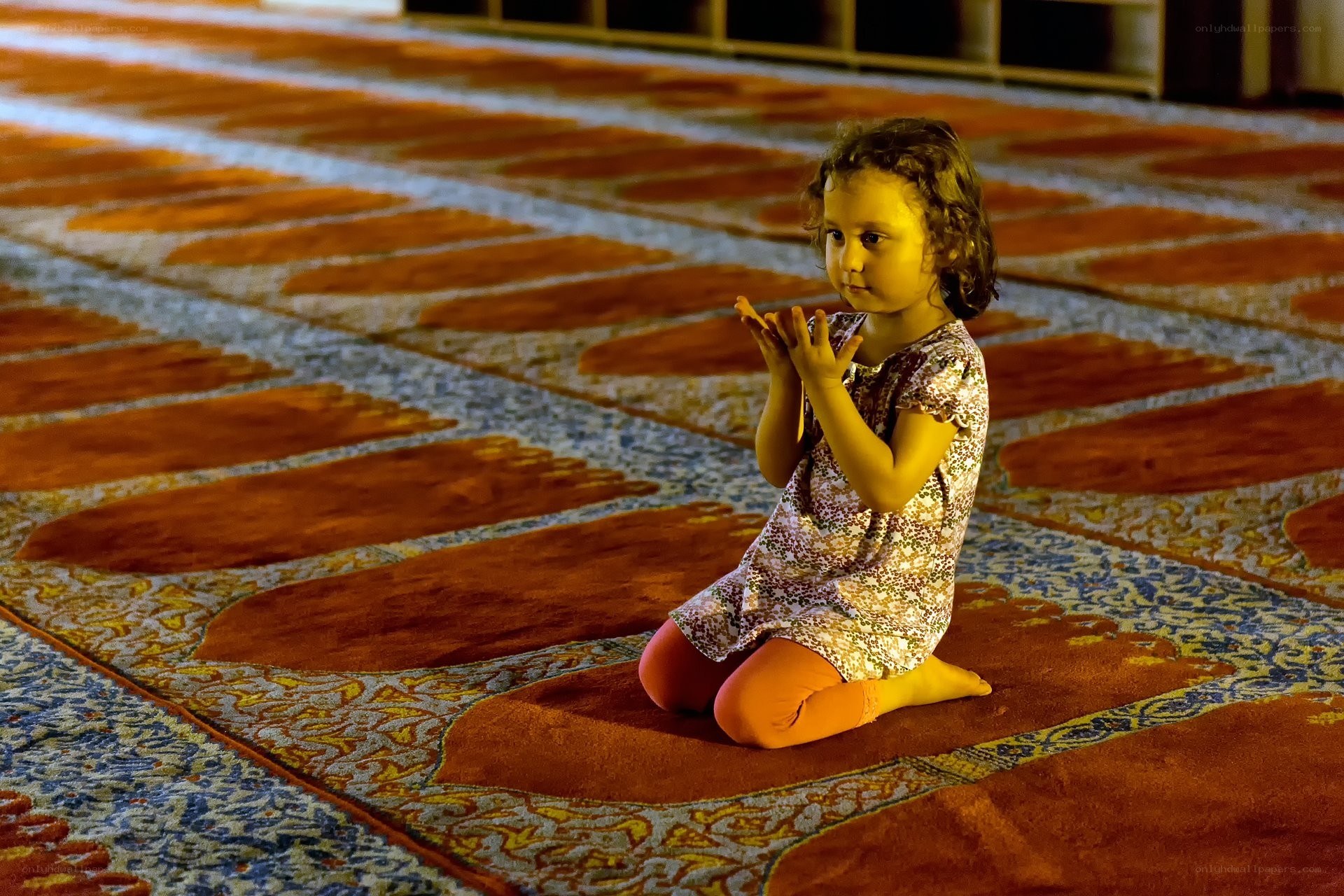 child praying in a mosque