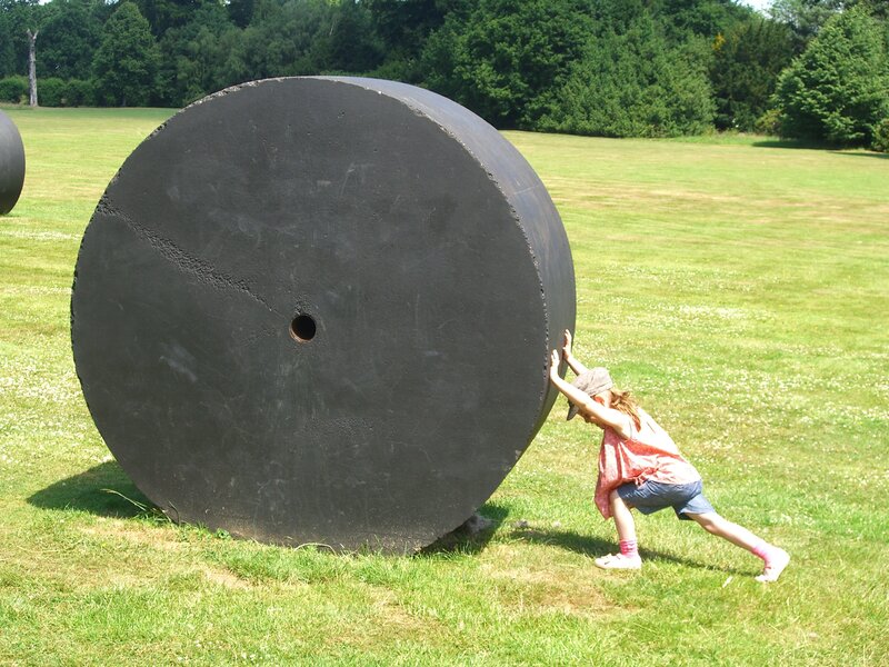 Child Pushing Large Wheel
