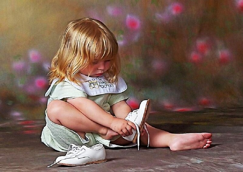 child putting on shoes