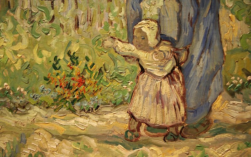 child reaching for flowers