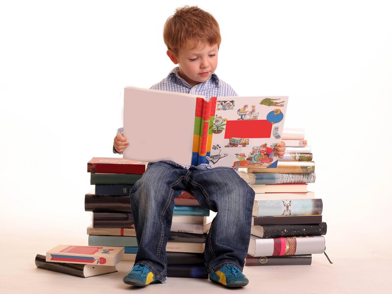 child reading book on stack