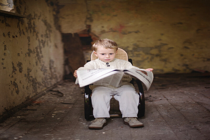 Child Reading Newspaper