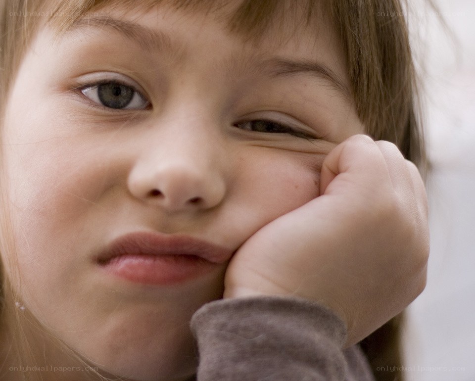 child resting hand on cheek