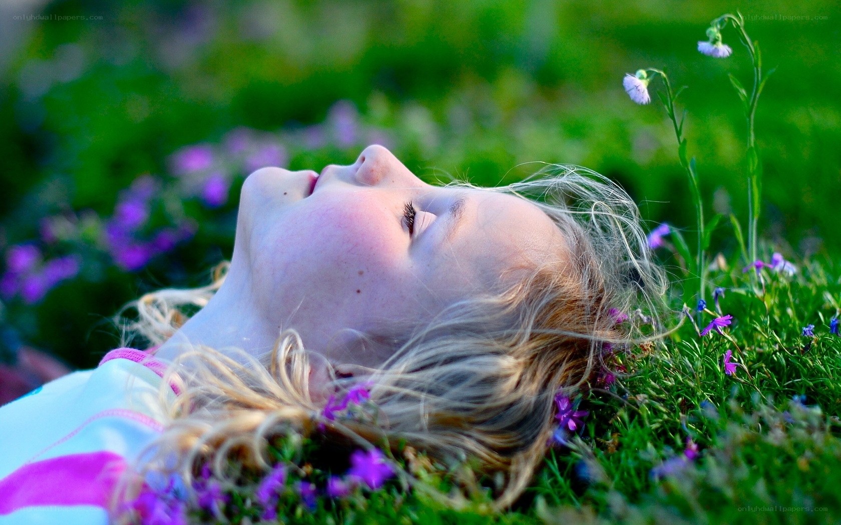 child resting in a field