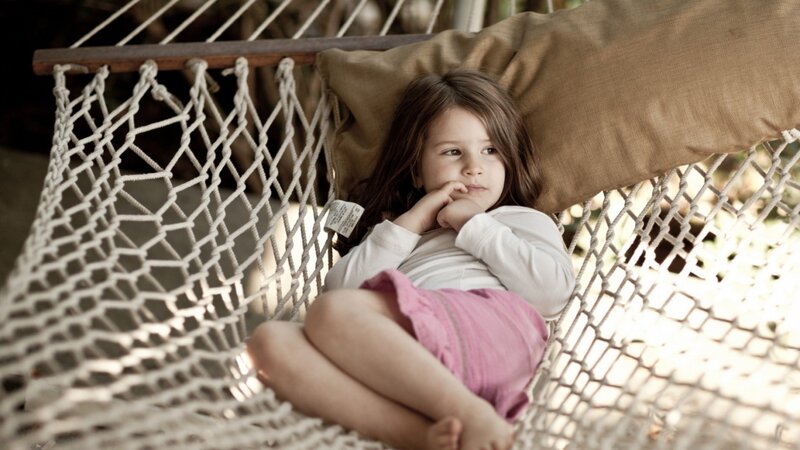 child resting in a hammock