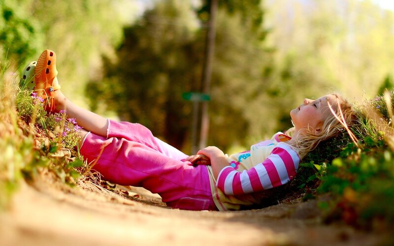 child resting in nature