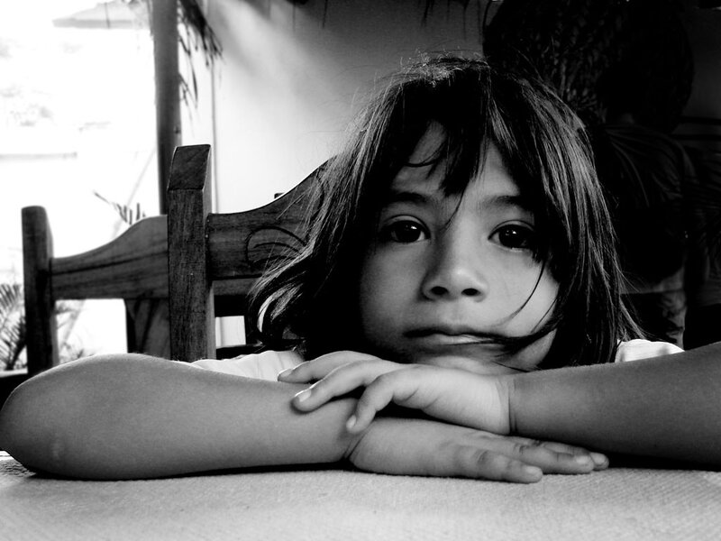 Child Resting on Table — Black, Contemplative
