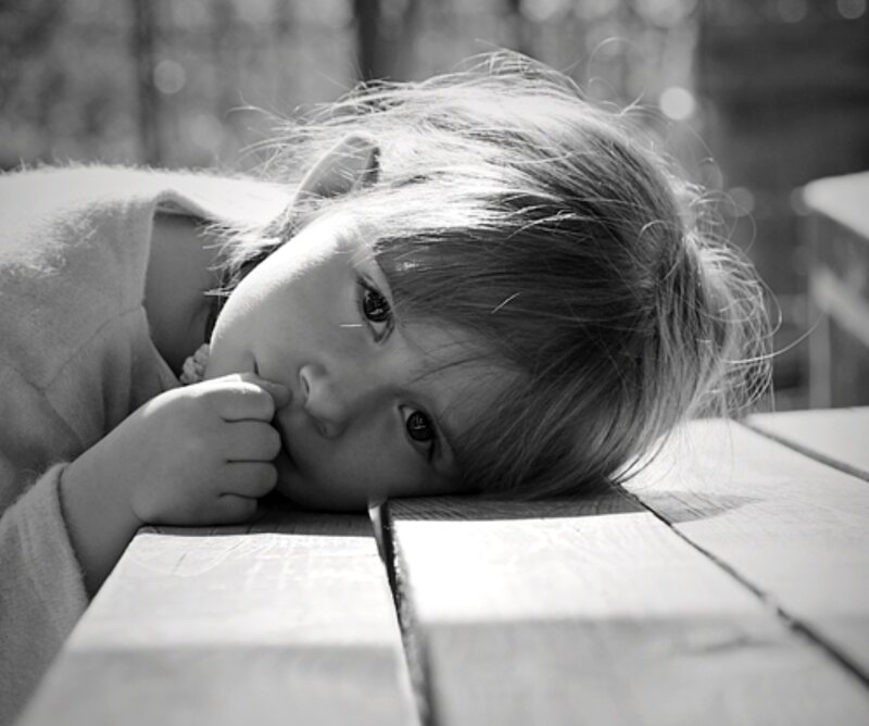 Child Resting on Table — Black