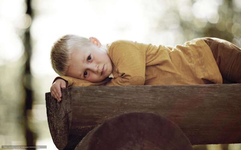 child resting on wooden beam