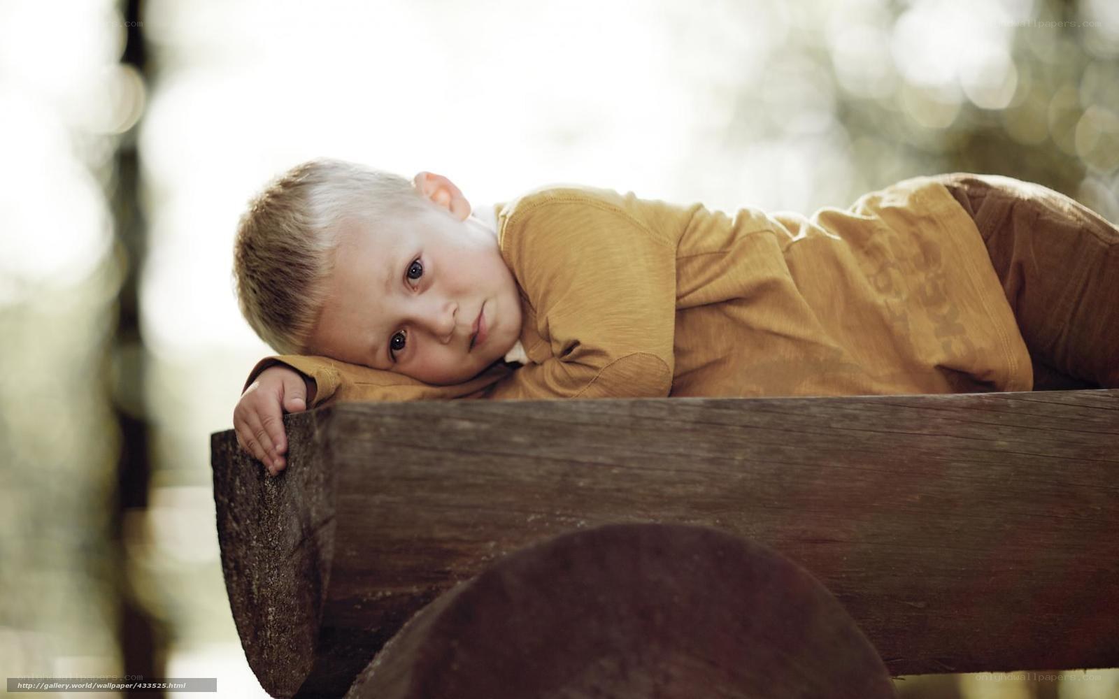 child resting on wooden beam