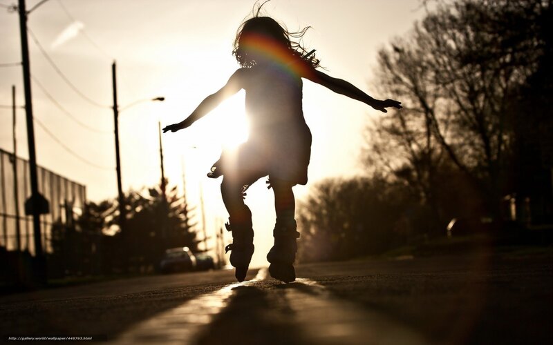 child rollerblading at sunset