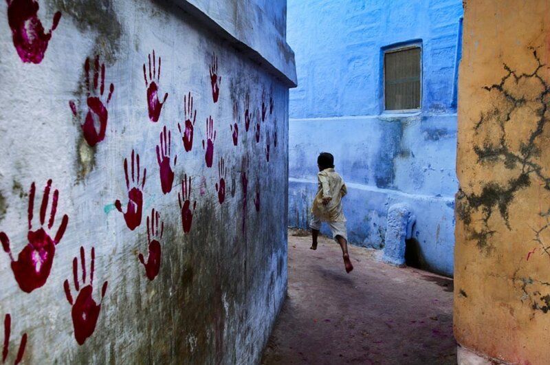 Child running in blue alley
