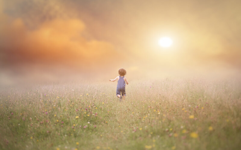 Child Running in Field — Yellow