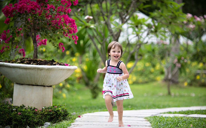 Child Running in Garden — Green