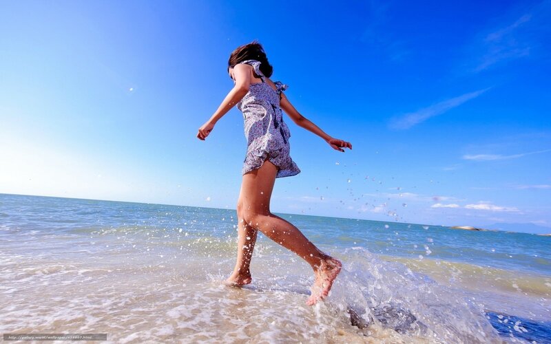 child running in ocean waves
