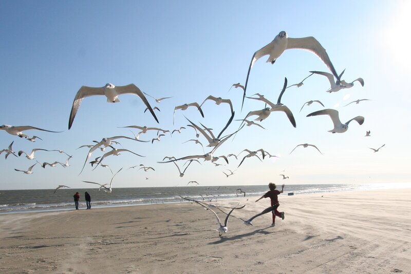 Child Running on Beach — Blue