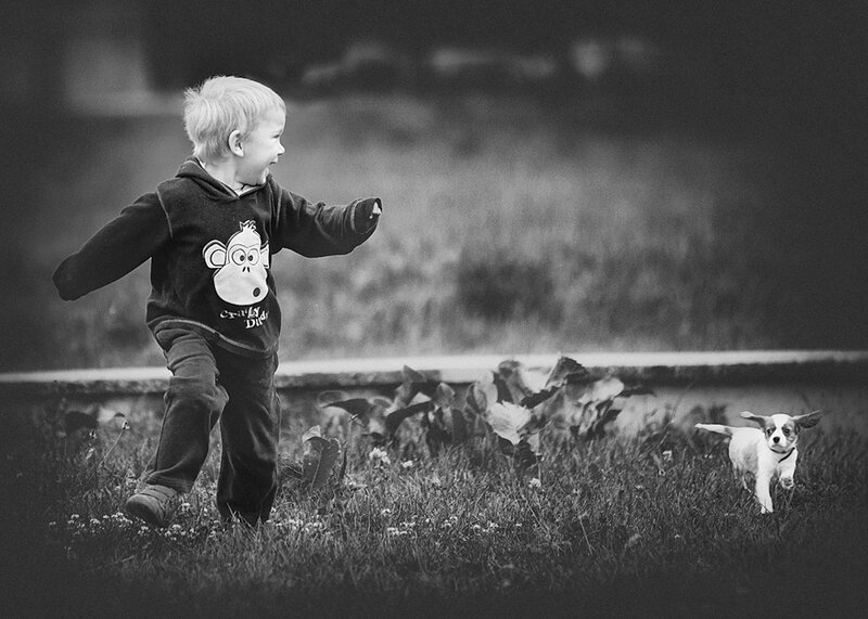 Child Running with Puppy