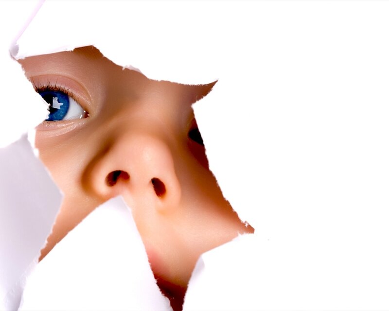 Child's Face Through Paper — White, Curious