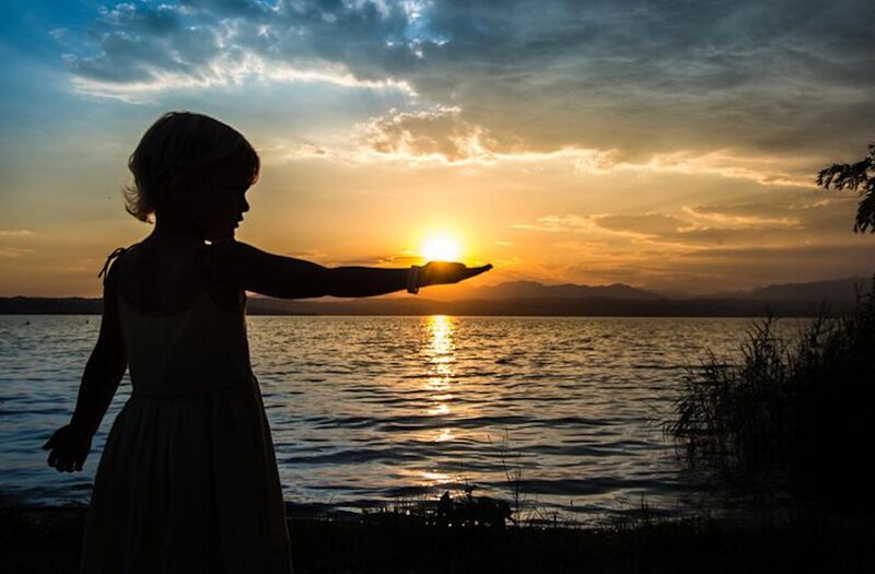 Child Silhouetted at Sunset