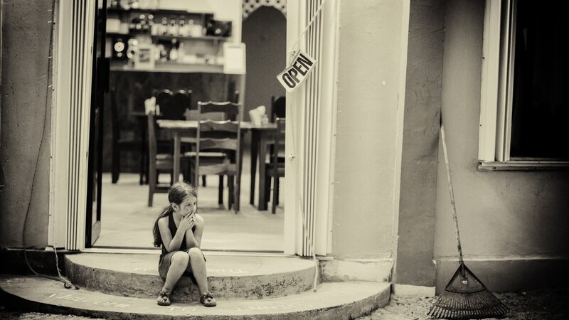 child sitting at doorway