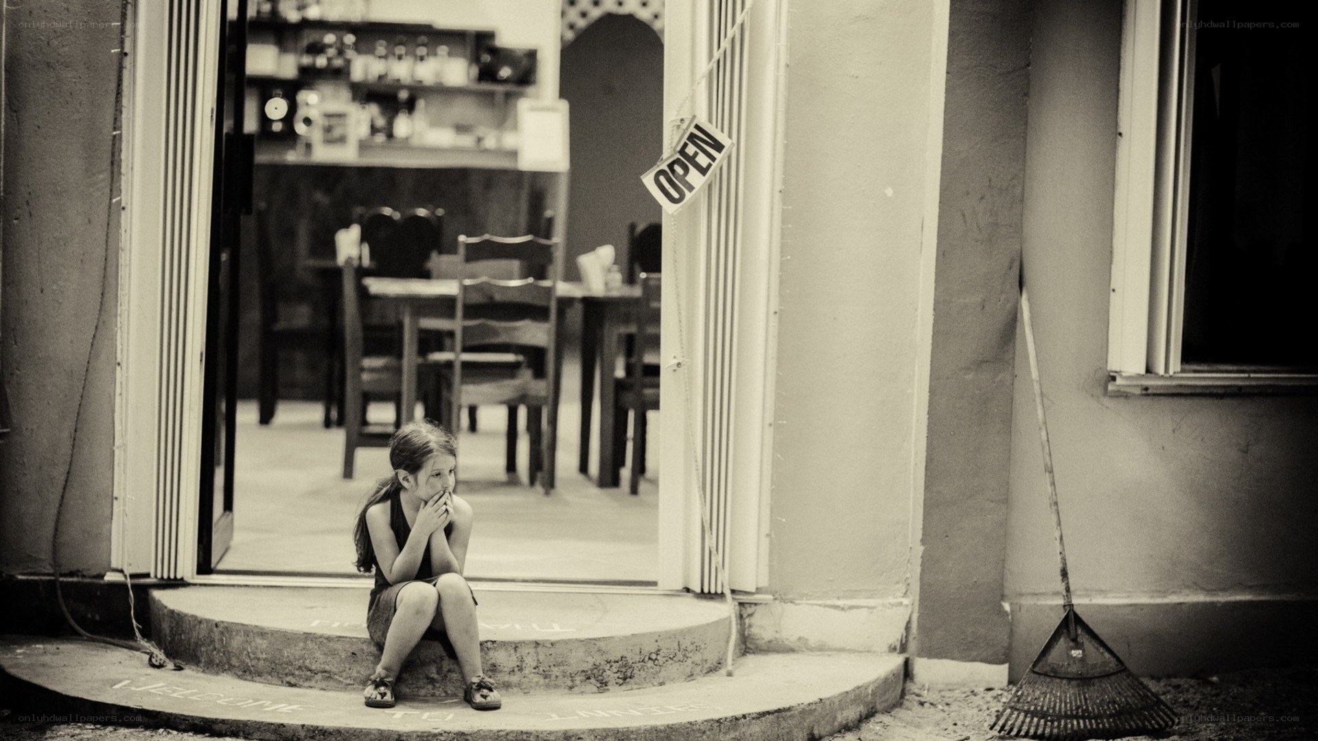 child sitting at doorway