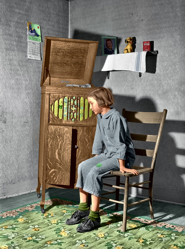Child sitting by a record player