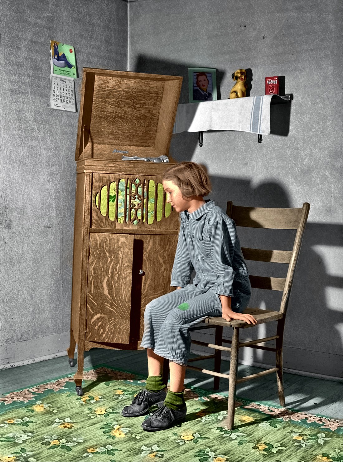 Child sitting by a record player