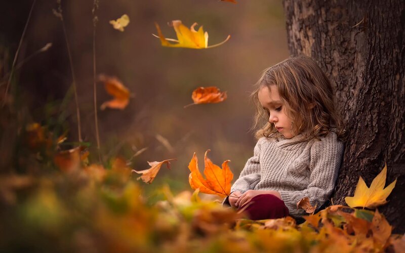 Child Sitting by Tree
